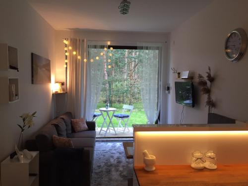 a living room with a couch and a table at RESET ul. Ratibora 66 in Jurata