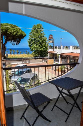 a balcony with a chair and a view of the beach at Al Saliceto Hotel in Patti