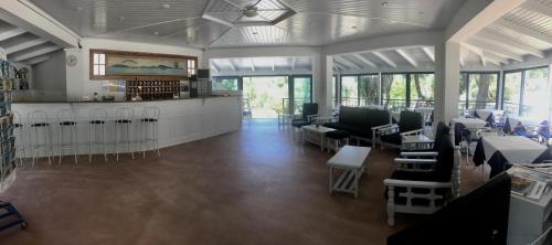 a library with chairs and tables in a room at Lofos Strani in Zakynthos