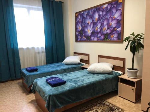 En eller flere senger på et rom på Hotel Kupavna