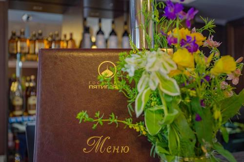 a sign with a vase of flowers in a store at Pyatigorsk Hotel in Pyatigorsk