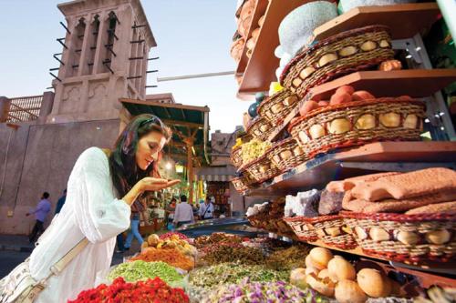 una donna in piedi di fronte a un mercato con verdure di Florida Square Hotel (Previously known Flora Square Hotel) a Dubai