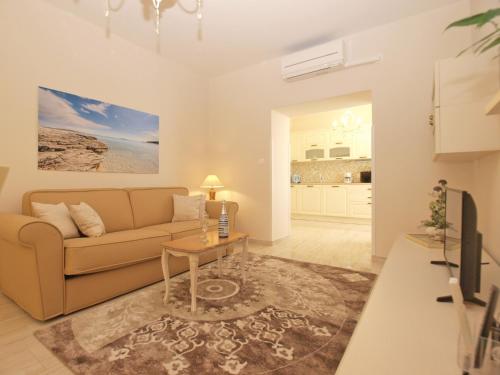 a living room with a couch and a table at Apartmenst SLavica 1654 in Ližnjan