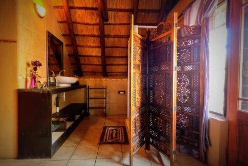 a room with a door and a counter in a room at Khaya Umdani Guest Houses in Marloth Park