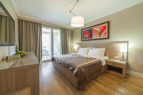 a hotel room with a bed and a window at Apartments Grifone Lux in Herceg-Novi