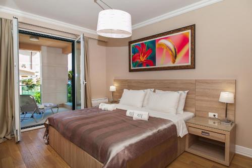 a bedroom with a large bed with a painting on the wall at Apartments Grifone Lux in Herceg-Novi