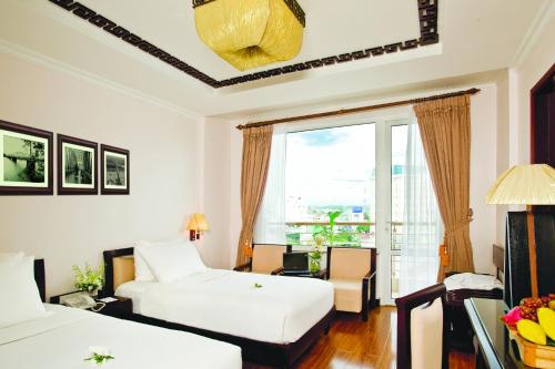 Postel nebo postele na pokoji v ubytování Cherish Hue Hotel