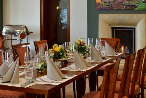 a long table with napkins and flowers on it at Hotel Rech in Brilon