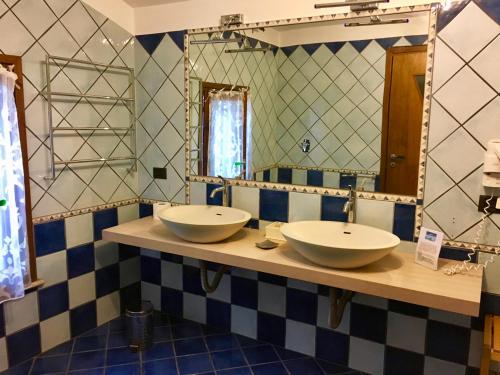 bagno con 2 lavandini e specchio di Agriturismo Corte Rocca a San Giorgio Di Mantova