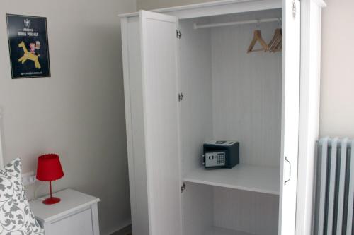 a bedroom with a white closet with a book shelf at La Sosta Navarra Bed & Beer in Gubbio