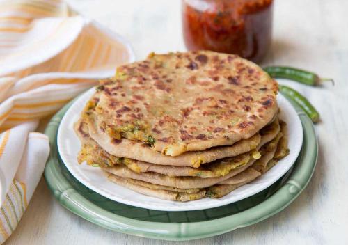 a stack of pancakes on a plate on a table at The Maple Leaf @ DLF Cyber City in Gurgaon