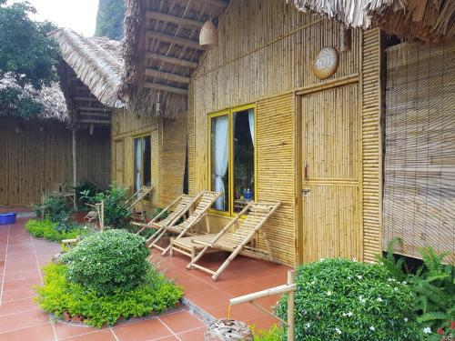 a group of chairs sitting outside of a building at Tam Coc Horizon Bungalow in Ninh Binh