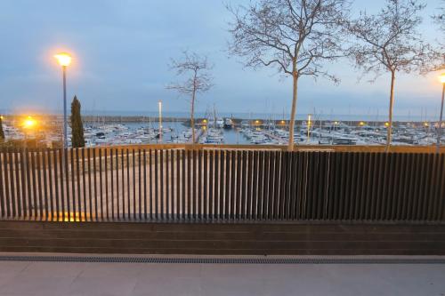 a bench in front of a marina with boats at Domus Aurea in Palamós