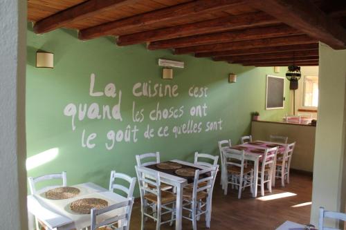 a dining room with tables and white chairs at Il Piccolo Borgo in Montalto di Castro