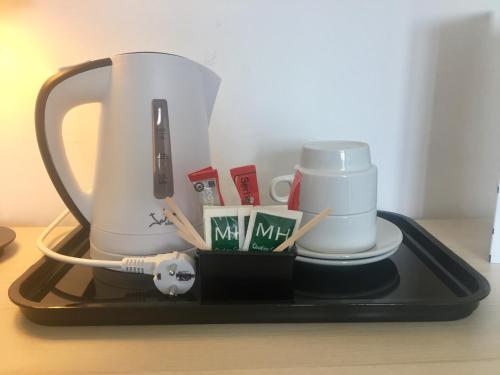 a tray with a coffee maker and cups on a table at Hotel Luxor in Playa de Palma