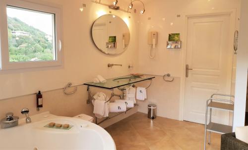 a bathroom with a sink and a mirror at Private Hôtel - Adults Only in Porto-Vecchio