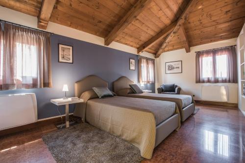 a bedroom with a bed and a table and windows at Ca' Del Monastero 9 Collection Spacious Apartment up to 5 Guests in Venice