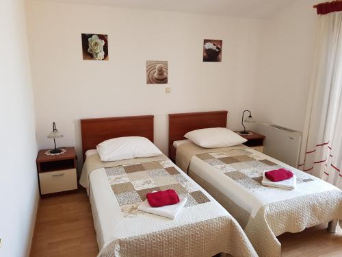 A bed or beds in a room at Apartments Ivona 2