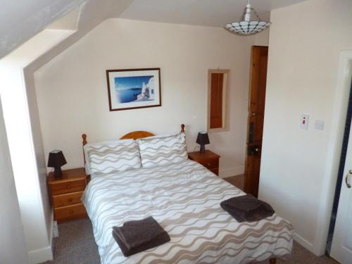 a bedroom with a bed with two pillows on it at The Quaich B&B in Inverness