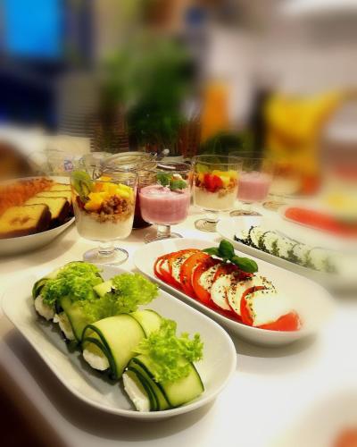a table with plates of food and glasses of drinks at Hemma rooms by IKEA in Zbąszyń