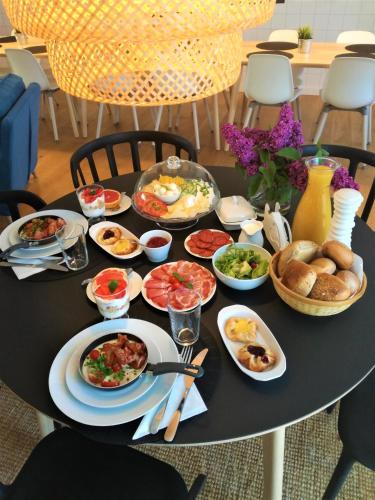 a black table with plates of food on it at Hemma rooms by IKEA in Zbąszyń