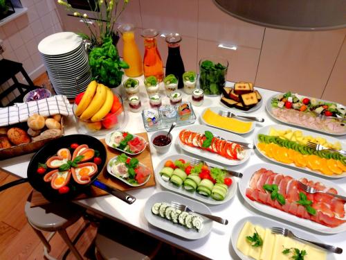 a table with many different types of food on it at Hemma rooms by IKEA in Zbąszyń