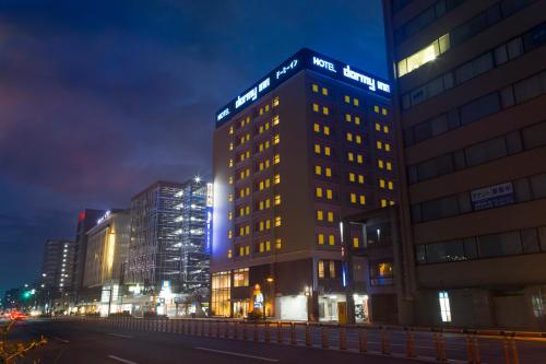 a lit up building in a city at night at Dormy Inn Toyama Natural Hot Spring in Toyama