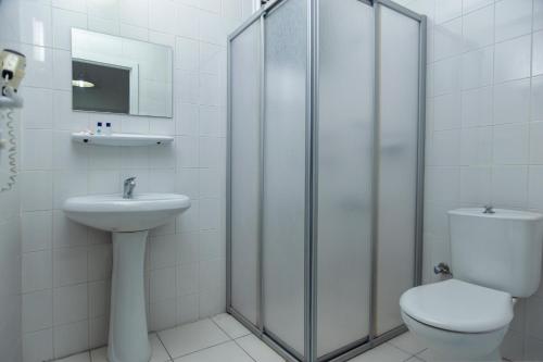 a bathroom with a shower and a toilet and a sink at THE S APART & SUITES hOTEL in Alanya