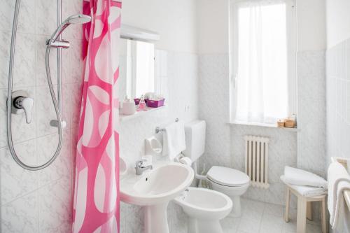 a bathroom with a sink and a toilet and a shower at Hotel Europa in Finale Ligure