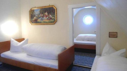 a hotel room with two beds and a mirror at Hotel Krone in Gößweinstein