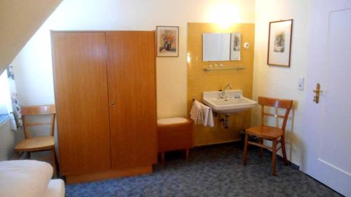 a small bathroom with a sink and a cabinet at Hotel Krone in Gößweinstein