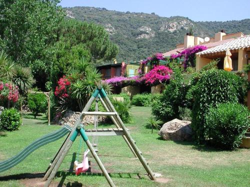 a ladder in a yard with a playground at Residence Helios in Cargèse