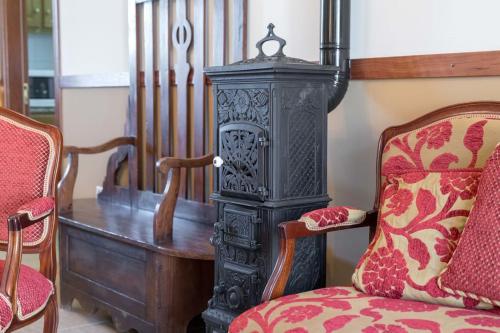 a room with a chair and a table and a stove at Quinta Sta Luzia Carrascal in Vila Flor