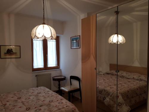 a bedroom with two beds and a window and two lights at Casa vacanze Maria in Agropoli
