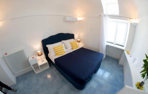 a small bedroom with a bed and a window at Domus Fortunae B&B in Bacoli