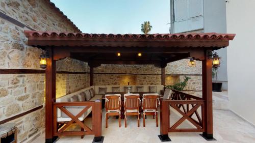 a wooden gazebo with chairs and a table at Hotel 1207 Special Class in Antalya
