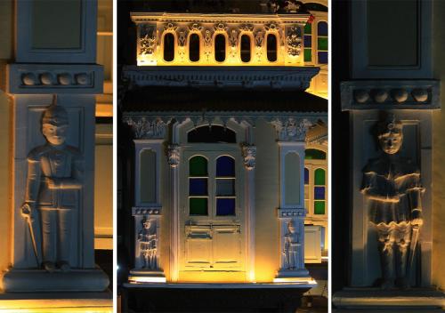 a blue lego building with a statue in the middle at French Haveli in Ahmedabad