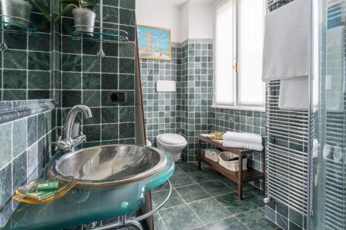 a bathroom with a sink and a toilet at Lovely Apartment Overlooking Lake Como by Rent All Como in Carate Urio
