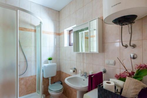 a bathroom with a toilet and a sink and a shower at Apartment Placido Krk in Krk