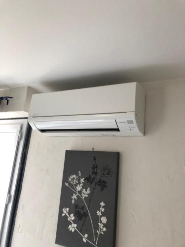 a kitchen with a white stove hood in a room at Central Hotel in Niort