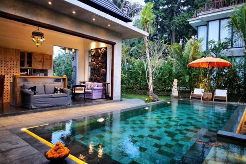 a swimming pool in the backyard of a house at deLodtunduh Villa 2 in Ubud