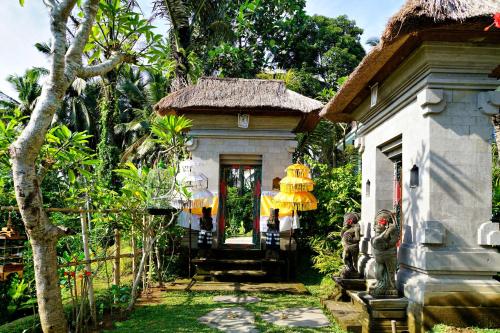 a house with two people standing in front of it at deLodtunduh Villa 2 in Ubud