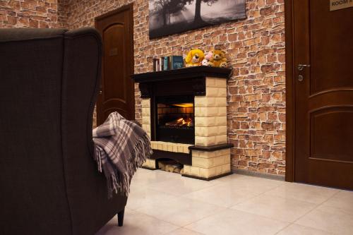 a brick building with a fire place in front of it at London Mini-hotel in Yekaterinburg