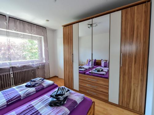 リンダウにあるFerienwohnung Schliestädt-Görgeのベッドルーム1室(ベッド2台、大きな鏡付)