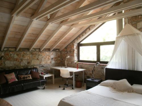 a bedroom with a bed and a desk in a room at Joanna in Stavroupoli