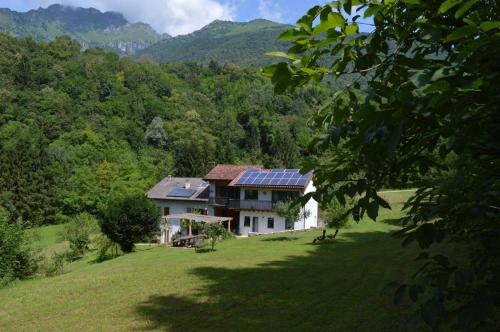 a house with solar panels on top of a field at Alla Casetta B&B in Cesiomaggiore