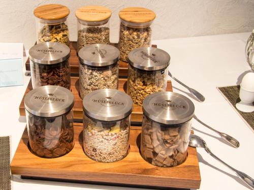 a group of five jars filled with different types of seeds at REGIOHOTEL Wolmirstedter Hof Wolmirstedt in Wolmirstedt
