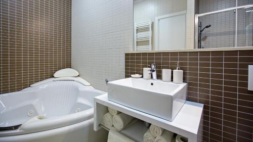 a bathroom with a white sink and a toilet at Dream Hotel in Velika Gorica