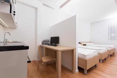 a room with a desk with a computer on it at Dream Hotel in Velika Gorica