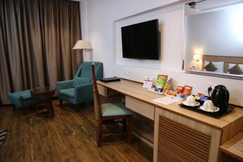 a hotel room with a desk and a chair at Ana Clarks Inn, Panchkula in Panchkula